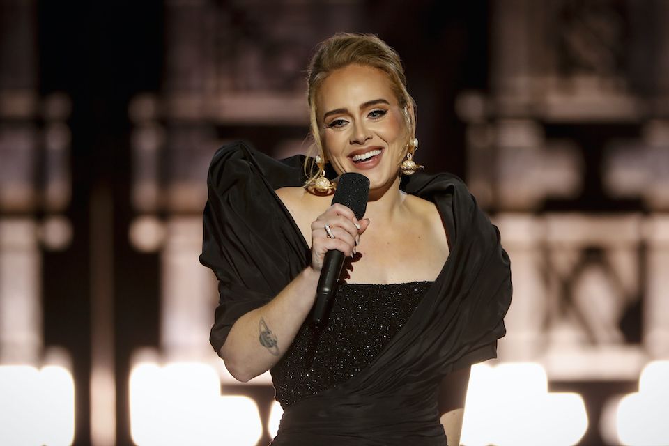 1637055626 28 adele on stage performing press releasing woman singing 